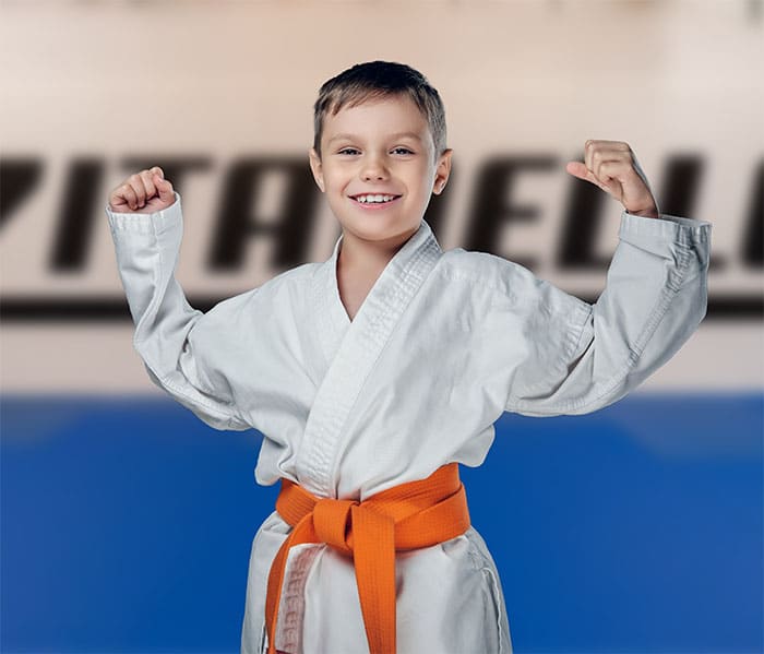 Kind in BJJ Gi mit orangem Gürtel